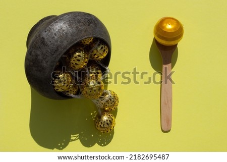 Christmas garland in cast iron and on a wooden spoon on a lemon-yellow background. Preparing a holiday