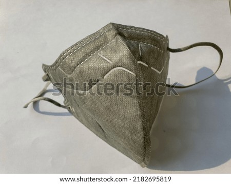 gray mask on white background with morning sun