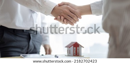 Business success, Real estate agents and customers shake hands to congratulate after signing a contract to buy a house with land and insurance, Acceptance,  handshake and agreement concept.
