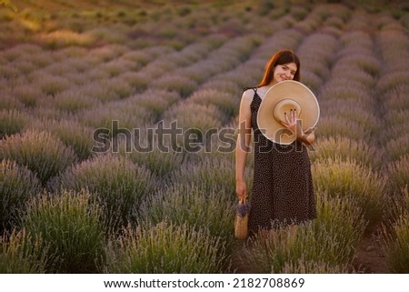 Portrait of a woman with a straw hat in a lavender field