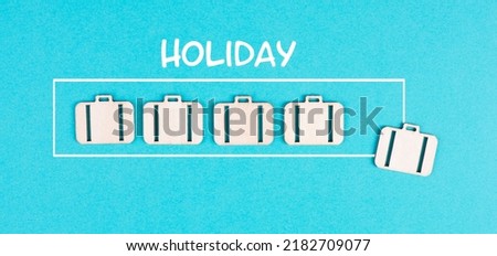 Progress bar with suitcases, holiday loading ist standing on the paper, planning a trip for the weekend, vacation and travel concept Royalty-Free Stock Photo #2182709077
