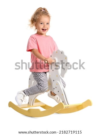 Funny little girl with rocking horse on white background Royalty-Free Stock Photo #2182719115