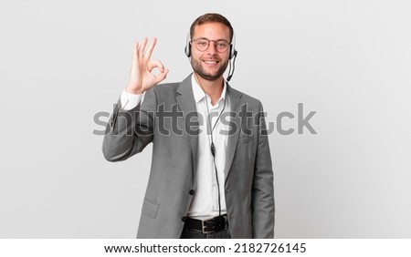telemarketer businessman feeling happy, showing approval with okay gesture