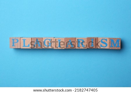 Word Plagiarism made of wooden cubes with letters on light blue background, top view Royalty-Free Stock Photo #2182747405