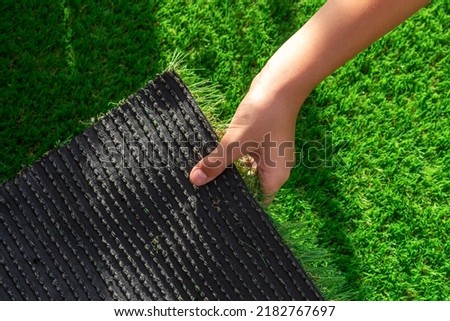 Close-up of the back of a roll of artificial turf. Synthetic artificial grass material easy to install and maintain Royalty-Free Stock Photo #2182767697