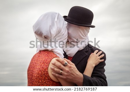 Faceless portrait of man kissing woman with white fabrics on their heads Royalty-Free Stock Photo #2182769187