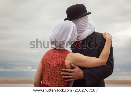 Faceless portrait of man kissing woman with white fabrics on their heads Royalty-Free Stock Photo #2182769189