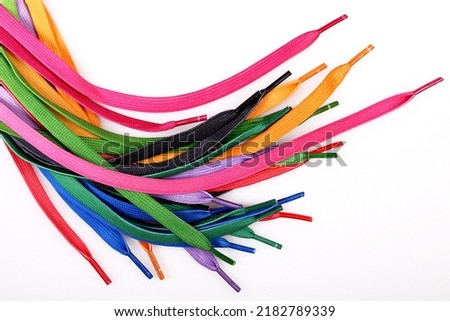 New shoelaces isolated on white background, colorful and bright, top view Royalty-Free Stock Photo #2182789339