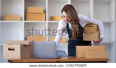 Portrait of Starting small businesses SME owners female entrepreneurs working on receipt box and check online orders to prepare to pack the boxes, sell to customers, SME business ideas online.
