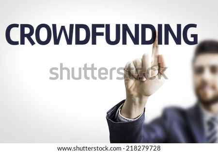 Business man pointing to transparent board with text: Crowdfunding