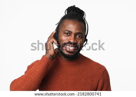 Closeup photo of IT specialist hotline worker, customer support manager african-american man in headset headphones consulting talking with clients isolated in white background
