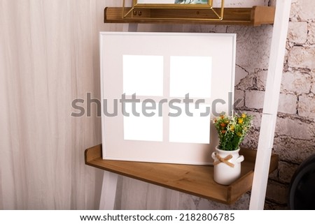 White picture frame with decorations. Mock up for your photo or text. Place your work, print art, white background, pastel color book. Photo realistic 3d illustration, home decor, home wall