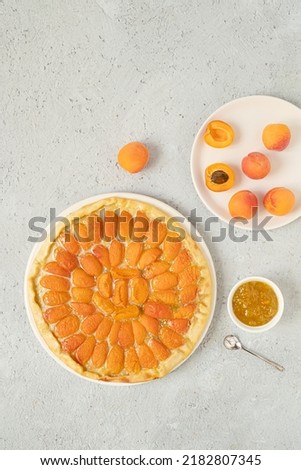 Peach-topped pizza and peaches on a gray background , homemade healthy food, top view with copy space