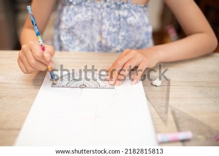 Hands of a child studying at home