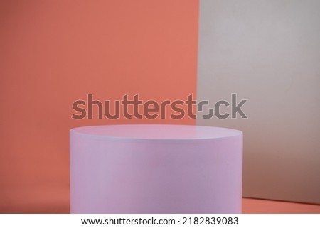 Empty podium for display cosmetic product. Platform arrangement in pink pastel color in trendy minimalist style. Composition of cylinders and cubes layout for feminine background