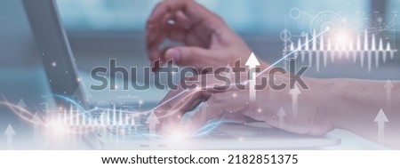 Businessman using computer laptop,stock graph and chart icon background,concept growth and development business investment,stock market strategy making market plan and stock market fluctuations 