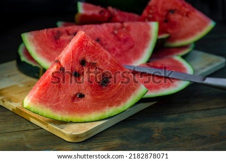 Delicious watermelon  outdoors wood table, GREEN  natural background  Slice sunny day, Heap,  Fresh ripe red, leaf, summer sunny garden juice drink organic sweet fruit, vegan food Tasty sliced board 