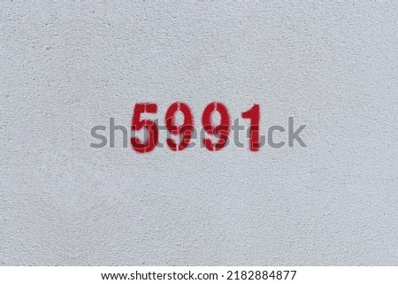 Red Number 5991 on the white wall. Spray paint.
