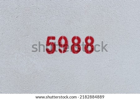 Red Number 5988 on the white wall. Spray paint.
