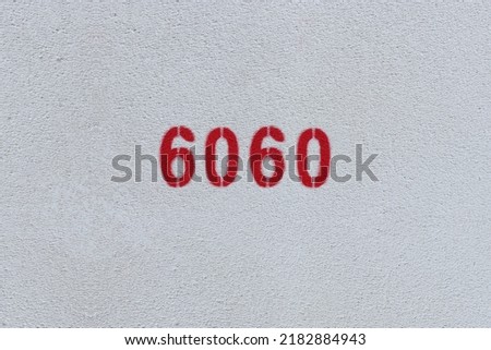 Red Number 6060 on the white wall. Spray paint.
