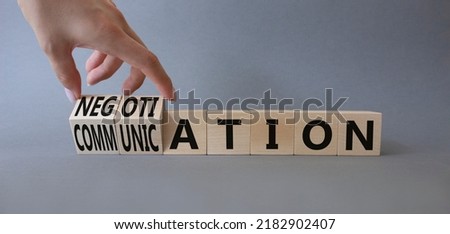 Negotiation vs Communication symbol. Businessman hand turns a cube and changes words Negotiation to Communication. Beautiful grey background. Business and Negotiation Communication concept. Copy space Royalty-Free Stock Photo #2182902407