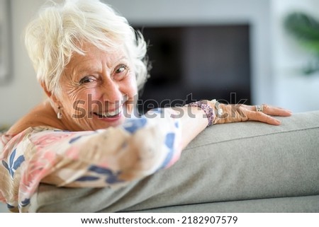 An Active beautiful senior woman in the living room. Royalty-Free Stock Photo #2182907579