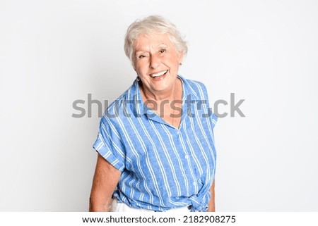 Happy smiling retired senior woman looking at camera isolated on white background