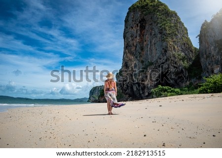 Young woman vacationing on the Thai beaches. Woman with hat on the beach. Woman on vacation in Thailand. Copyspace