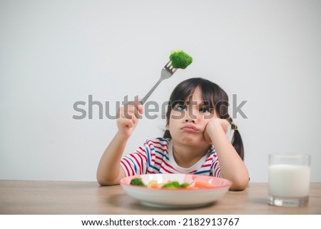 Nutrition healthy eating habits for kids concept. Children do not like to eat vegetables. Little cute girl refuses to eat healthy vegetables. Royalty-Free Stock Photo #2182913767