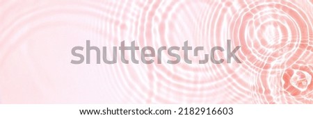 Pink water texture, cosmetic background pink water surface with rings and ripples Royalty-Free Stock Photo #2182916603