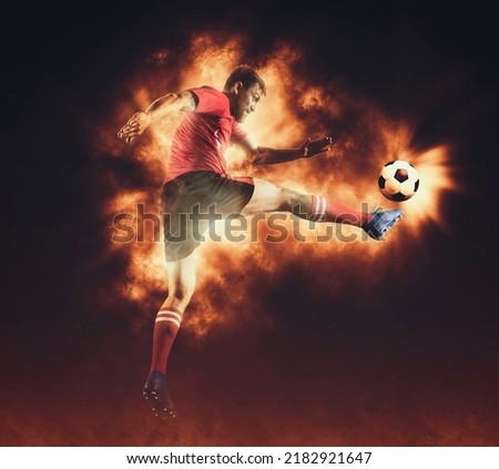 Soccer player in action on fire background