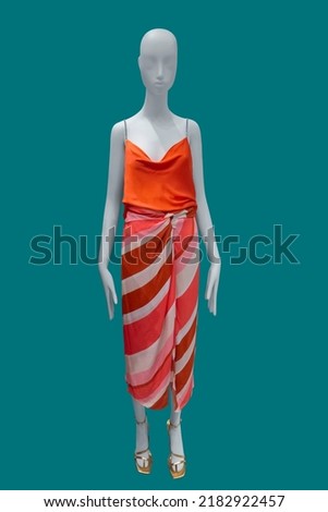Full length female mannequin wearing fashionable clothes isolated on blue background