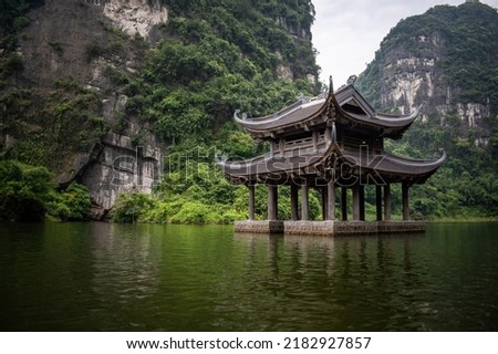 Vietnamese temple, surrounded by imposing mountains. Landscapes of Trang An, Vietnam. Characteristic landscape of Trang An, Vietnam Royalty-Free Stock Photo #2182927857
