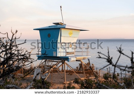 A lifeguard tower at sunset in El Matador Beach, Malibu, California Royalty-Free Stock Photo #2182933337