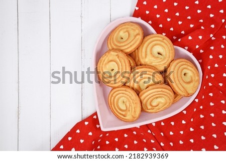 Round ring shaped spritz biscuits called 'Spritzgeback', a type of German butter cookies  Royalty-Free Stock Photo #2182939369