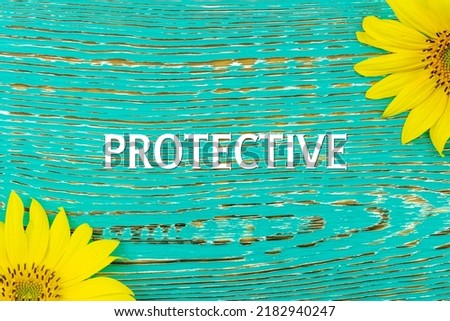 PROTECTIVE - text, yellow flowers, sunflowers, wooden background (copy space).