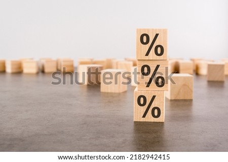 wooden cubes with percent signs. concept of financial and mortgage interest rate. gray background