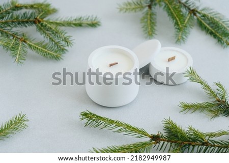 Group of White Candles of Various Sizes Top View. Flat Lay Christmas Tree Branches and Candles on Gray Background. Place Under Text. Christmas Theme