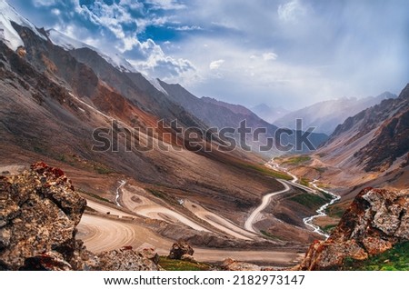 Curved, winding road in the mountains. Alpine road. Mountain pass, mountain range. Beautiful mountain landscape. Royalty-Free Stock Photo #2182973147