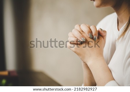 A woman praying worship believe. soft focus, praying and praise together at home. devotional or prayer meeting concept.