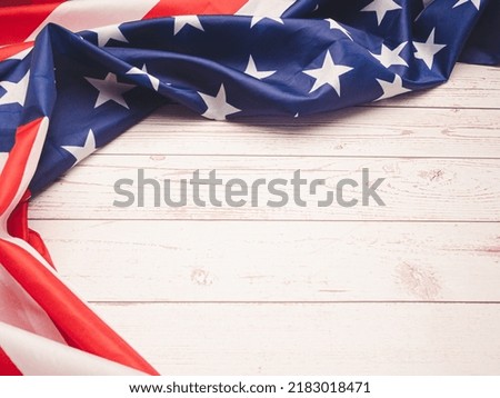Top view of the American flag on a wooden table with copy space for text. Top view. Close-up photo