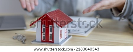 Selling a house with insurance, Sales managers or dealers have signed approval to open a housing project with a model house, Home-Real Estate and Insurance concept.