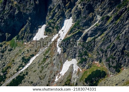 Snow on the rocks in the Tatra mountains in the summer season