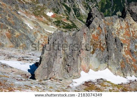 Snow on the rocks in the Tatra mountains in the summer season