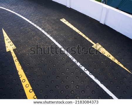 Directional arrows on a curved road of an empty car park