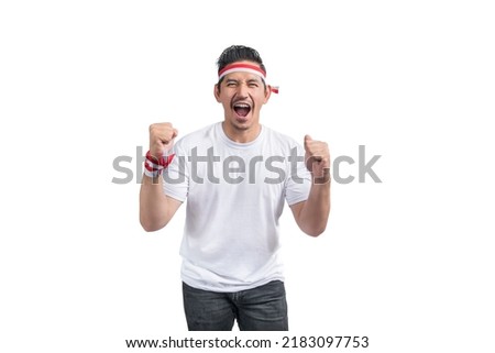 Indonesian men celebrate Indonesian independence day on 17 August isolated over white background Royalty-Free Stock Photo #2183097753