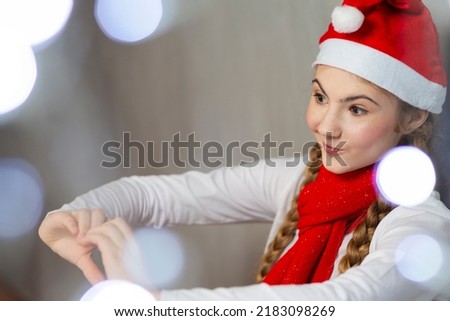 Happy Smiling Caucasian Girl Wearing Santa Hat Using Palms of Her Hands for Online Video Virtual Classroom on Laptop Device During Demonstration From Home. Horizontal Image