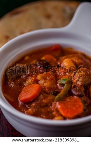 Soup with beans, meat, carrots, beans in a plate