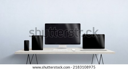 Turned off devices of different sizes on the desktop. Blank screen for responsive web page or app promotion. Computer display, laptop, tablet and smart phone Royalty-Free Stock Photo #2183108975