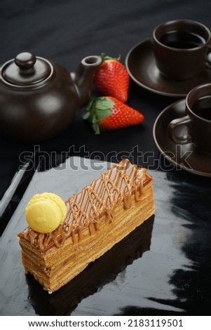 dessert honey cake on a black plate macro vertical photo
